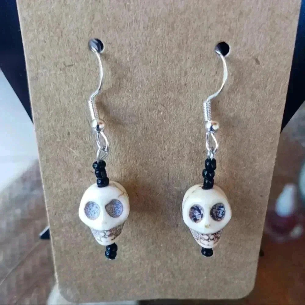 Set of really cool skulls earrings NWT....925 silver